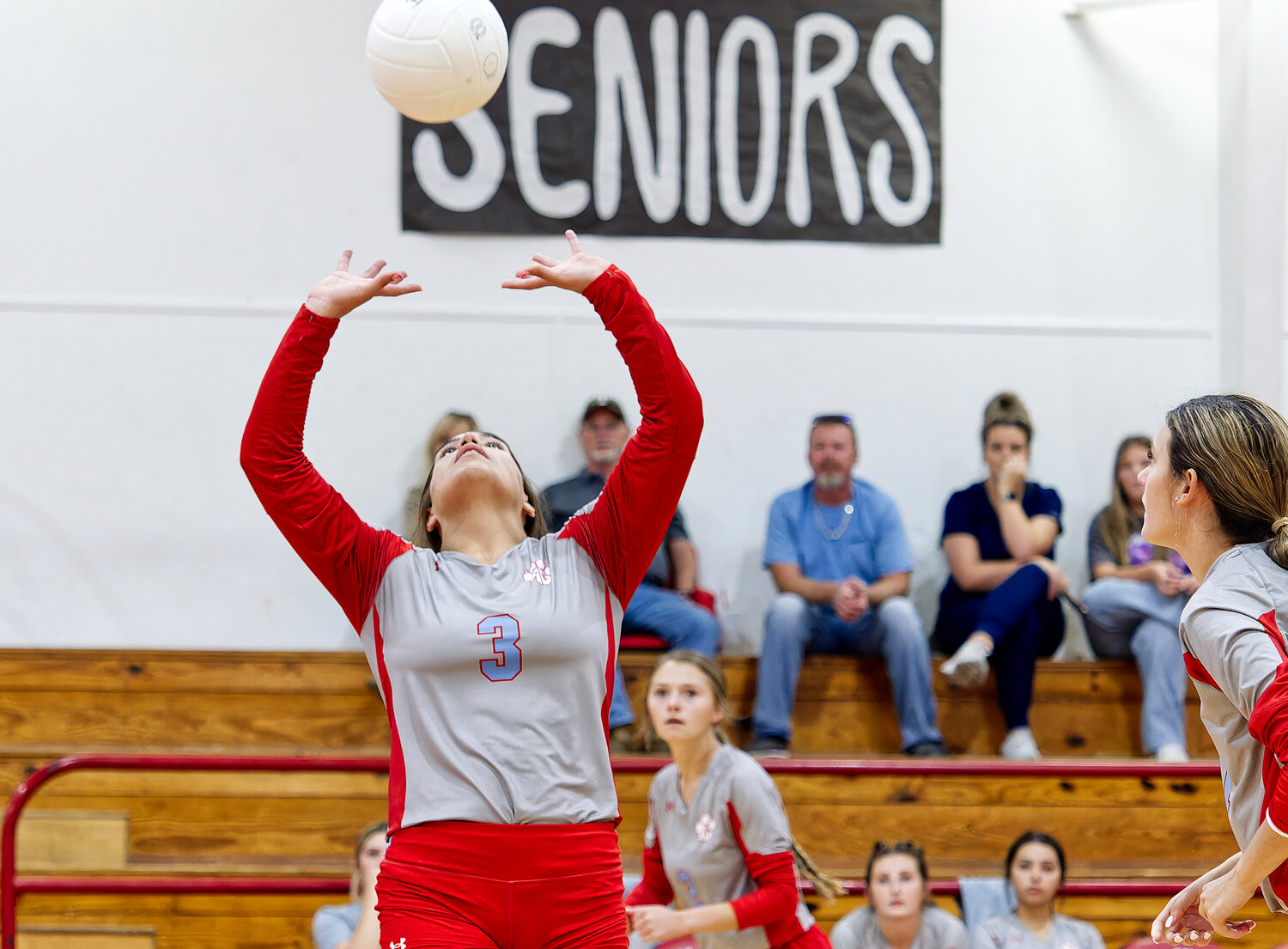 Erin Langston sets the ball as Kalli Trimble and Bailee Bishop anticipate their attack. [net numerous AG action shots]